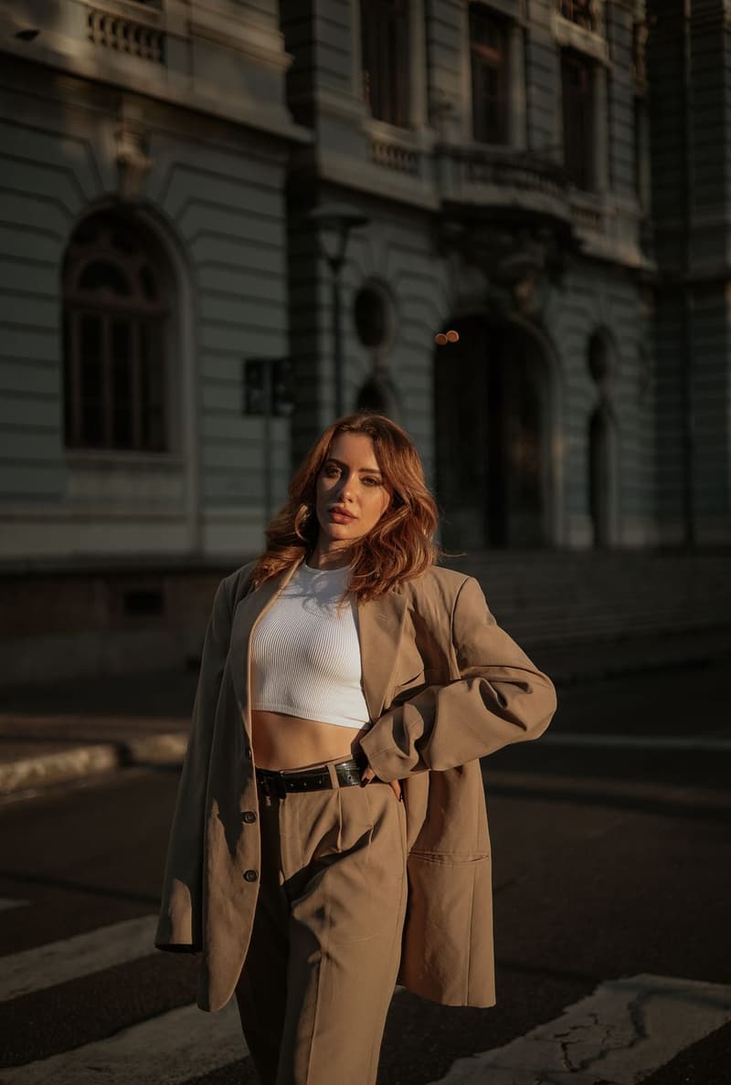 Woman in an oversized camel blazer and trousers on a city street